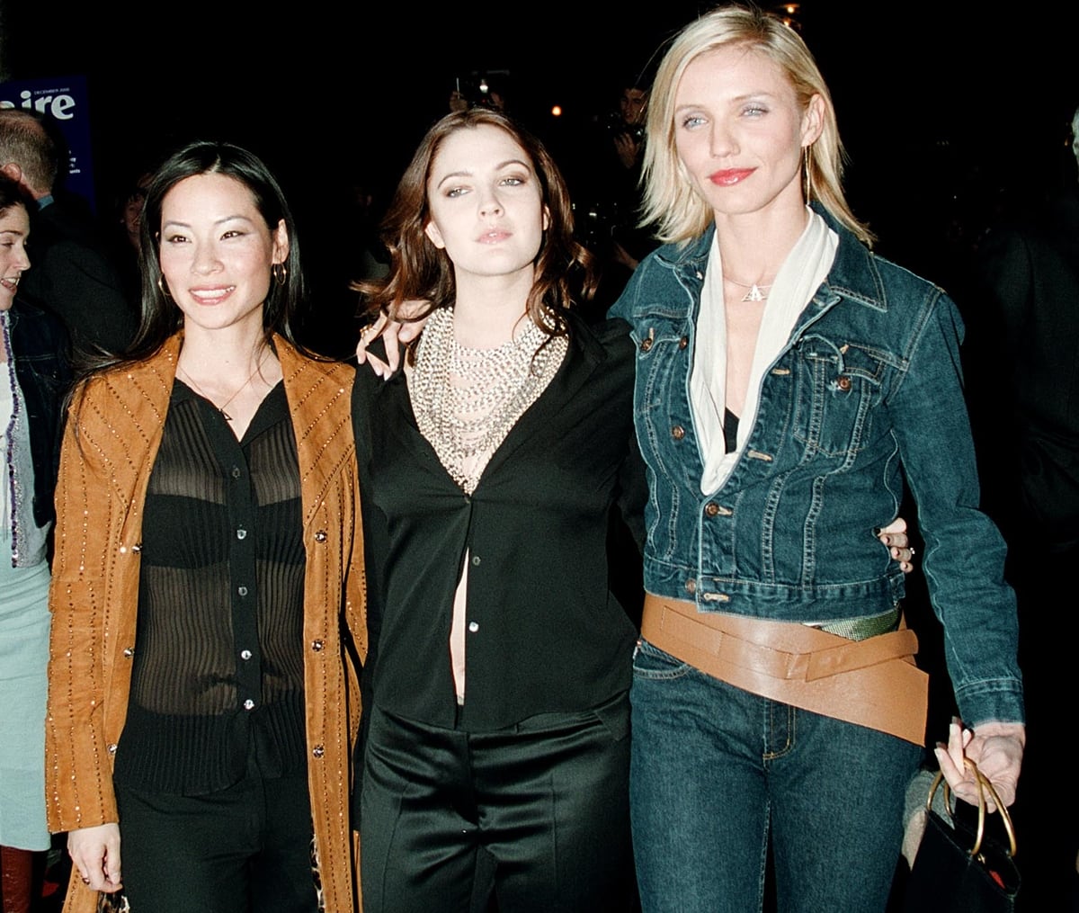 Lucy Liu, Drew Barrymore, and Cameron Diaz showcased their distinct early-2000s style at the Charlie’s Angels New York City premiere—Liu in sheer black with a studded suede coat, Barrymore in satin pants and layered pearls, and Diaz rocking a bold denim-on-denim look with a statement belt