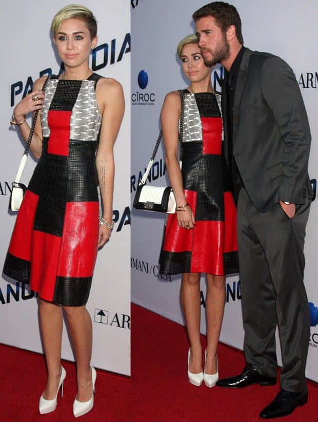 Miley Cyrus stuns in a mixed-media Proenza Schouler dress with a patch of snakeskin-print leather and white platform pumps, while Liam Hemsworth looks sharp in a tailored grey suit and black dress shoes