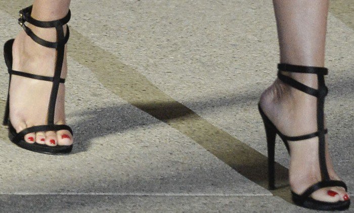 Reese Witherspoon shows off her feet in strappy black satin heels