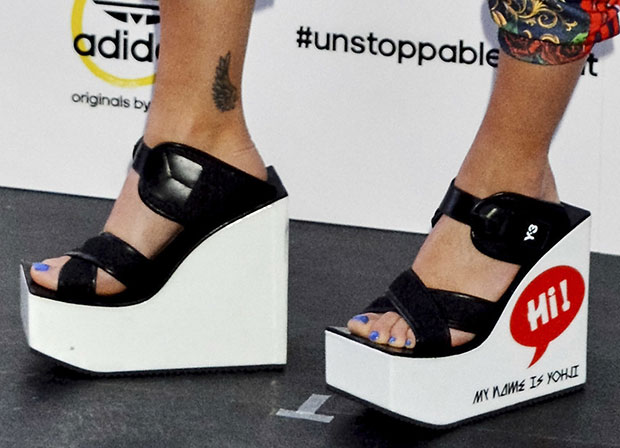 Rita Ora wearing Y-3 wedge sandals with Hi! My Name Is Yohji print