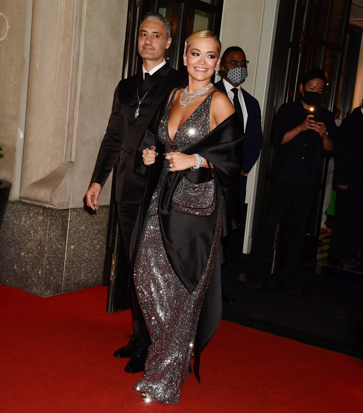 Rita Ora and Taika Waititi coordinated in sleek Prada at the 2021 Met Gala, with Ora’s shimmering gown and subtle peep-toe heels adding a touch of red-carpet sparkle to the polished, modern pairing