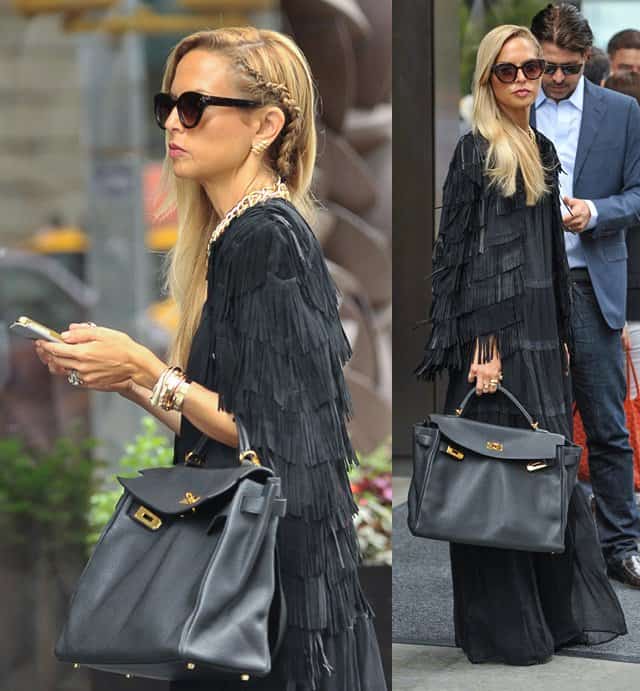 Rachel Zoe exudes sophistication in a black fringed cape and Hermes tote at New York Fashion Week