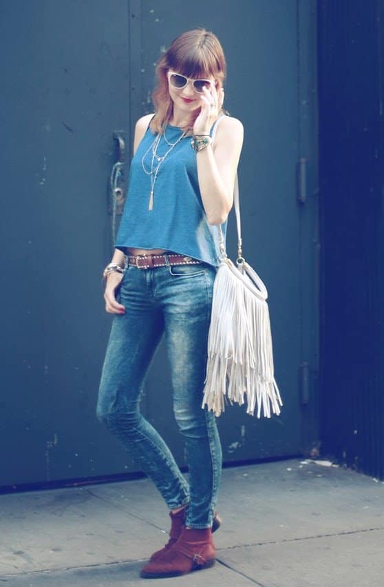 Veronica rocks blue jeans and a white fringe bag