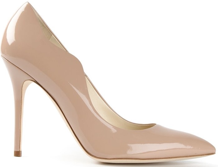 The Brian Atwood “Besame” pump features a softly sculpted nude patent leather silhouette with subtle wave detailing along the vamp, designed to flatter the arch and create a clean, leg-lengthening line