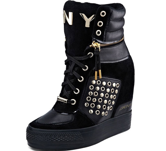 DKNY’s “Griffin” wedge sneakers combine quilted leather panels, oversized gold-tone hardware, and a hidden wedge sole, capturing the sporty-luxury sneaker trend that dominated mid-2010s fashion