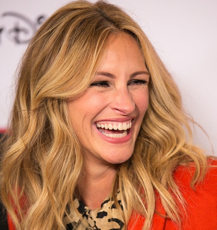 Julia Roberts radiates joy with her soft blonde waves, flawless makeup, and her signature wide, captivating smile