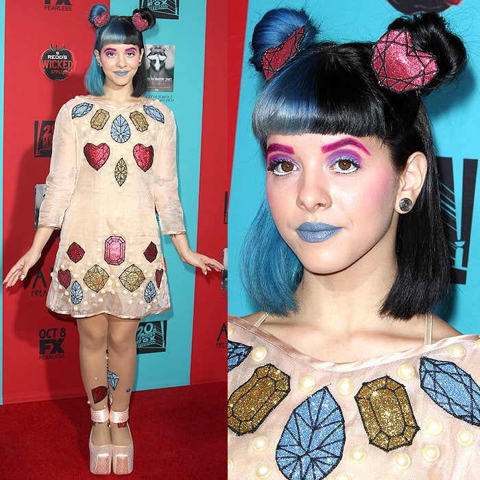 Singer Melanie Martinez brought her whimsical style to the American Horror Story: Freak Show premiere, pairing a jewel-embroidered shift dress with bold pink quilted platform shoes that amplified her playful, doll-like aesthetic