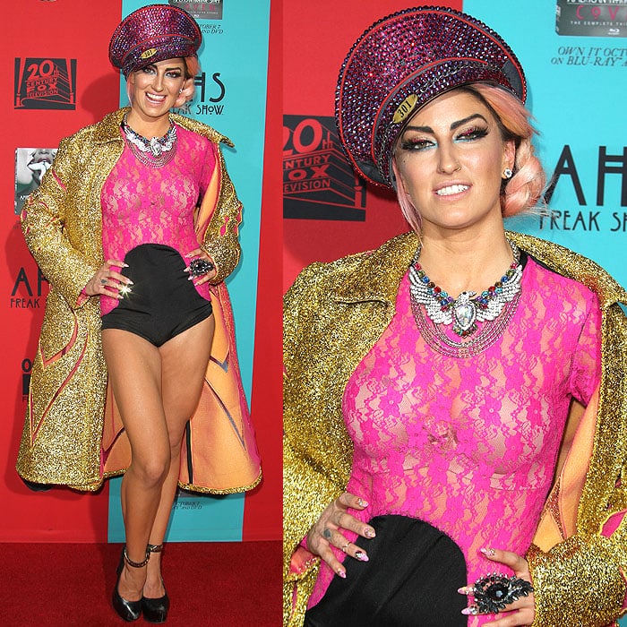 British singer Neon Hitch embraced maximalist glamour at the premiere in a hot-pink lace bodysuit, gold metallic coat, jeweled accessories, and black platform heels that added edge to her theatrical ensemble