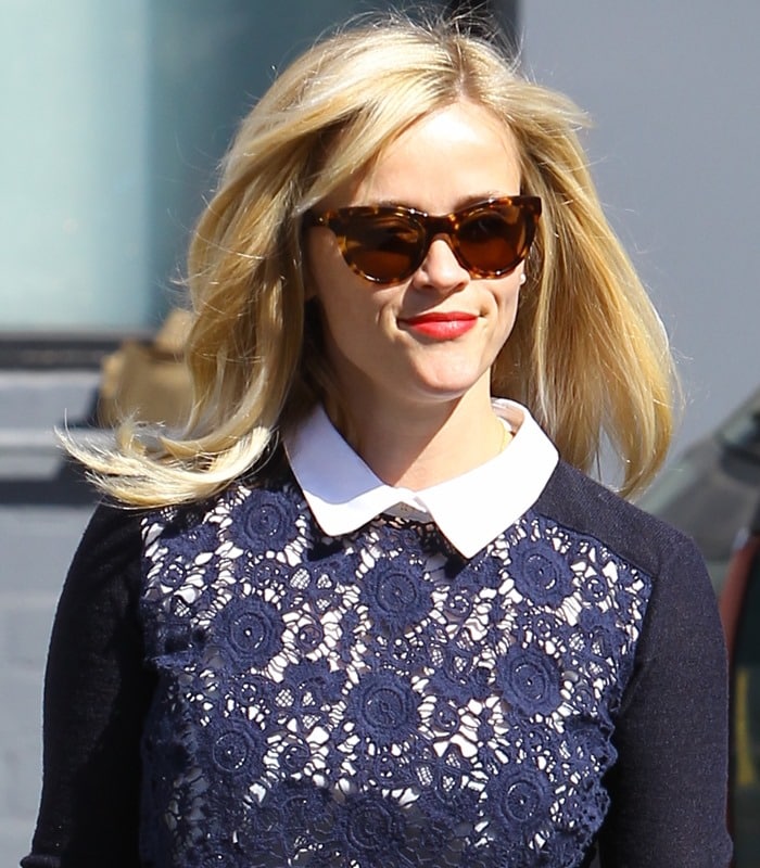 Reese Witherspoon wearing a flowery "Sandy" crewneck sweater by Tory Burch while visiting a hair salon in Beverly Hills