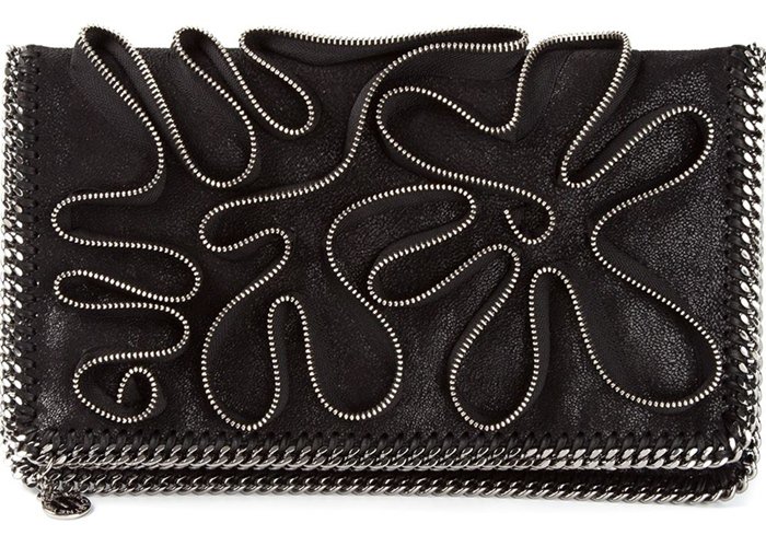 Stella McCartney “Falabella” black clutch featuring signature chain trim and intricate swirling embroidery for a bold, sculptural finish