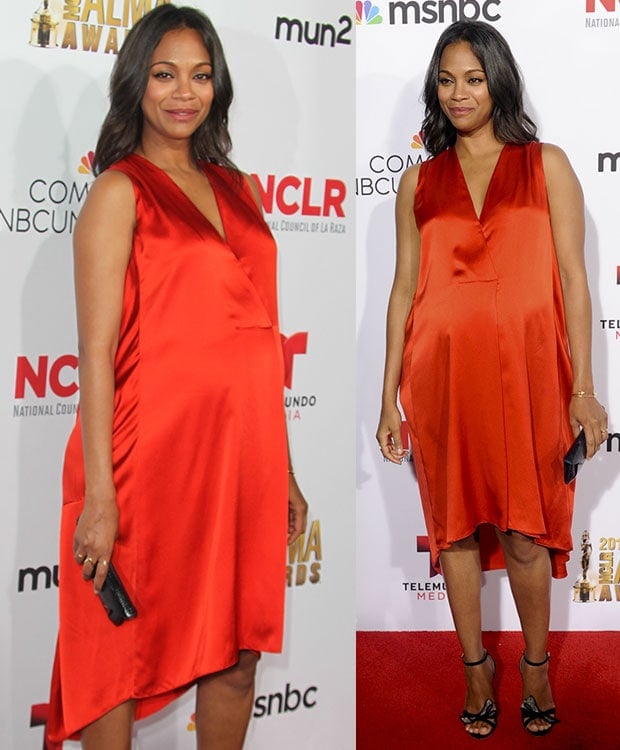 Zoe Saldaña wearing a bright orange-red Narciso Rodriguez dress