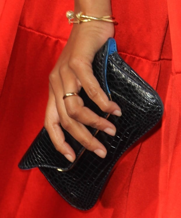 Zoe Saldaña showing off her jewelry and a black clutch
