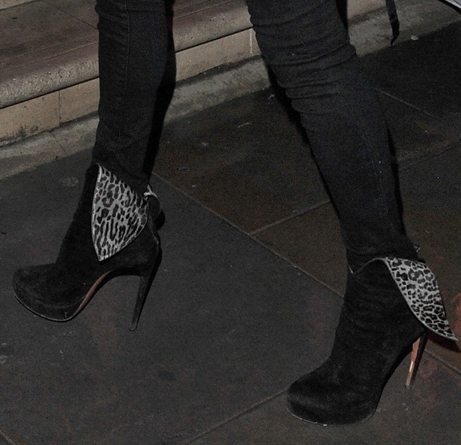 Kate Moss makes a bold statement in black suede wingtip boots, featuring fold-over leopard-print detailing for an effortlessly chic and edgy touch