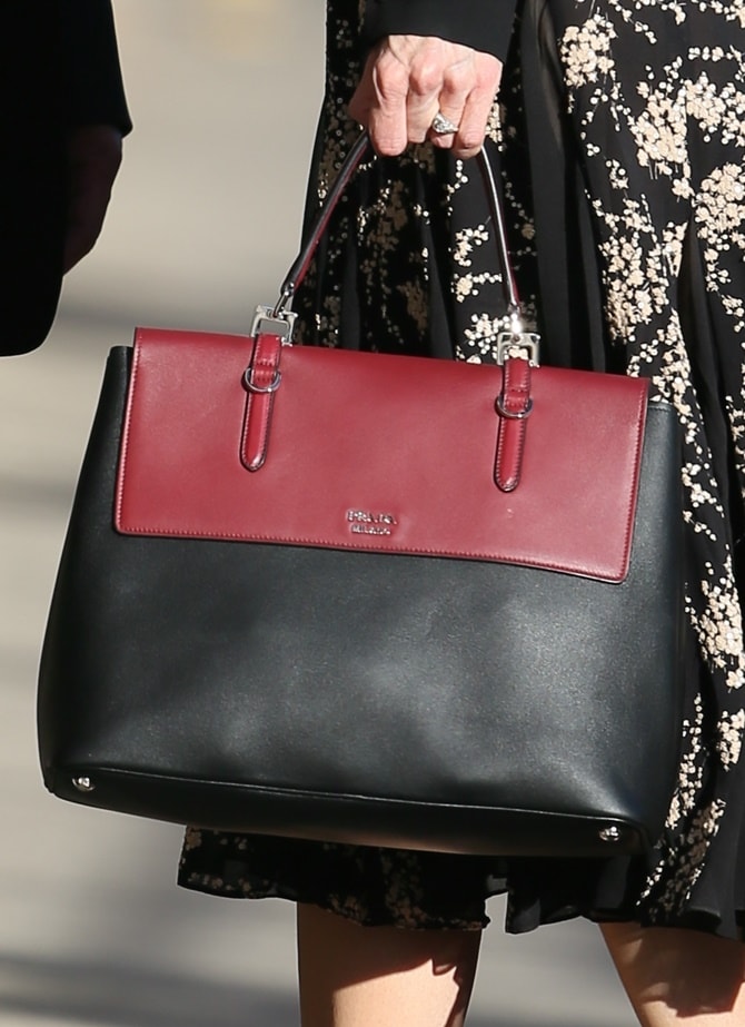 Nicole Kidman paired her look with a structured Prada top-handle bag in a bold black-and-burgundy colorblock design