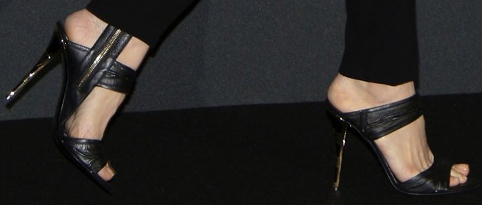 Angelina Jolie steps out in sleek black Balmain strappy sandals, highlighting her elegant feet and a sharp metallic stiletto heel