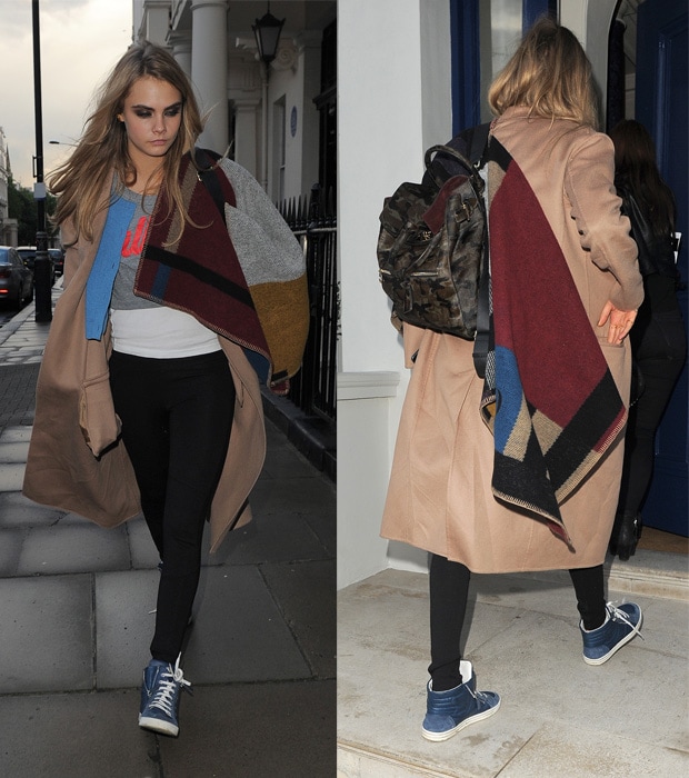 On May 12, 2014, in London, England, Cara Delevingne wore a Burberry Prorsum colour block check blanket poncho over a Burberry Prorsum Resort 2014 jacket, paired with Chanel coated toile and calfskin high-top sneakers