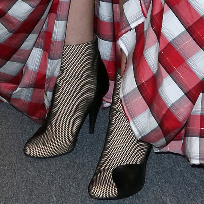 Mesh-overlay booties with curved leather panels on Evangeline Lilly