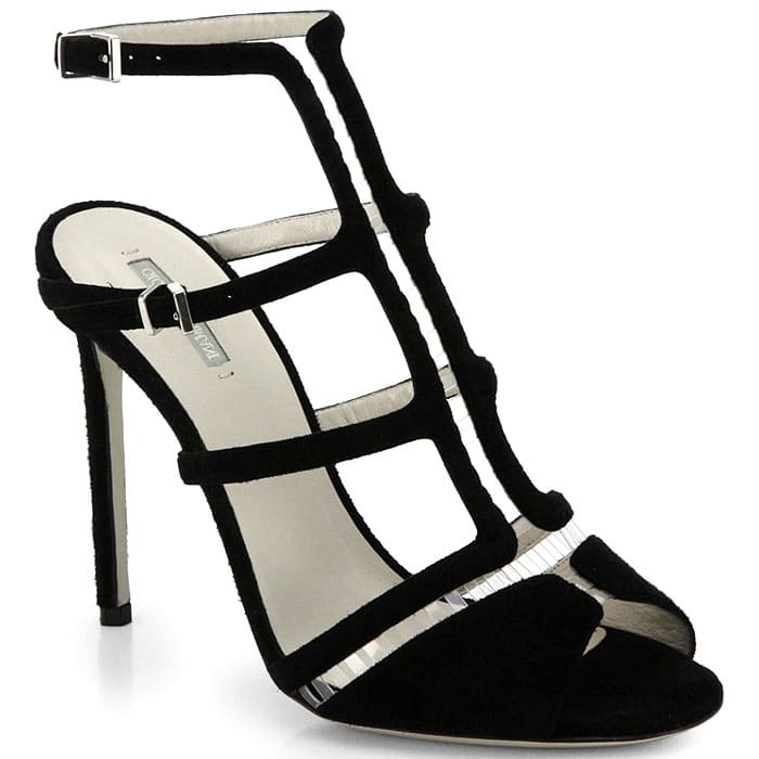 Crafted in black suede with a sculptural cage silhouette and a mirrored trim, these Giorgio Armani T-strap sandals blend architectural elegance with a sleek, high-heel finish