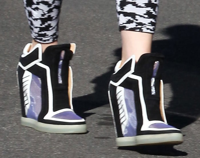 Gwen Stefani steps out in her futuristic L.A.M.B. “Freeda” wedge sneakers, featuring bold color blocking, suede and mesh paneling, and a hidden 4-inch heel for sporty, elevated style