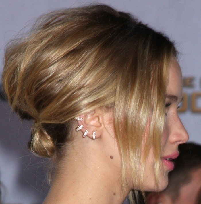 Jennifer Lawrence showcases a chic, softly textured updo, accented with delicate Vita Fede and Anita Ko ear cuffs