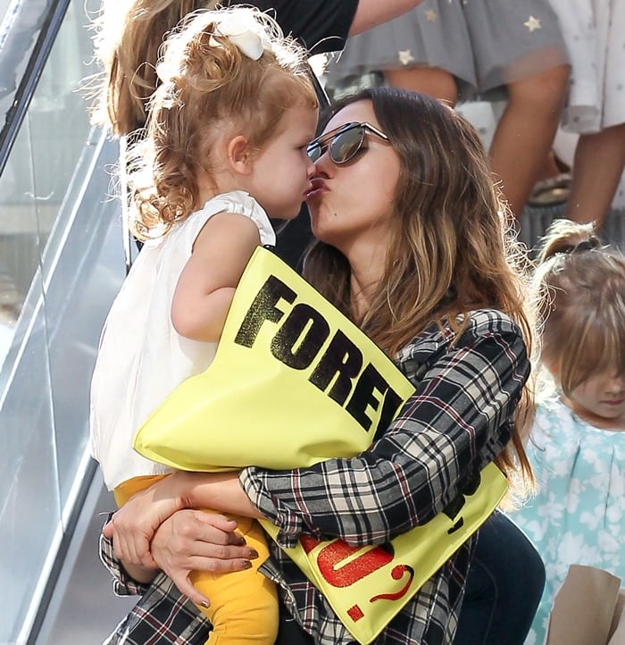 Jessica Alba wearing a black T-shirt by Krisa and a soft beige-and-black plaid cotton shirt by Lulu's