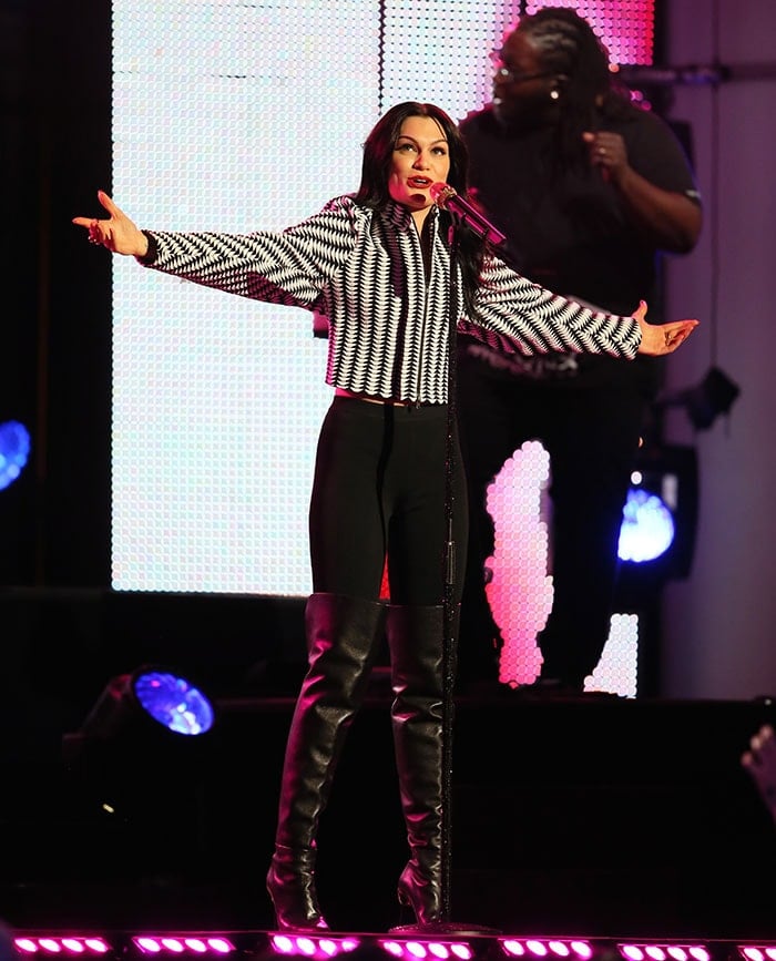 Jessie J owns the stage in a monochrome zip-up top paired with sleek, high-waisted leggings and bold, over-the-knee stiletto boots