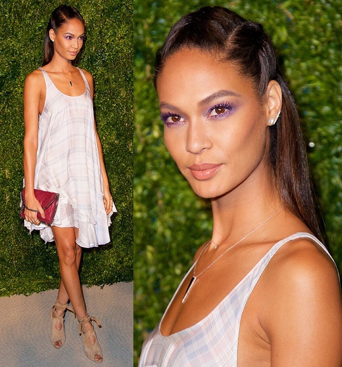 Joan Smalls' hair was pulled away from her flawlessly made-up face in a braided half up-do