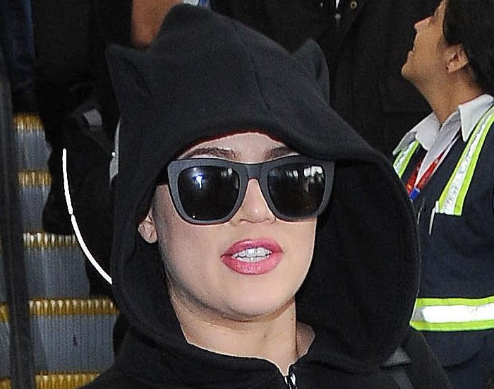 Khloé Kardashian in black jumpsuit featuring feline ears