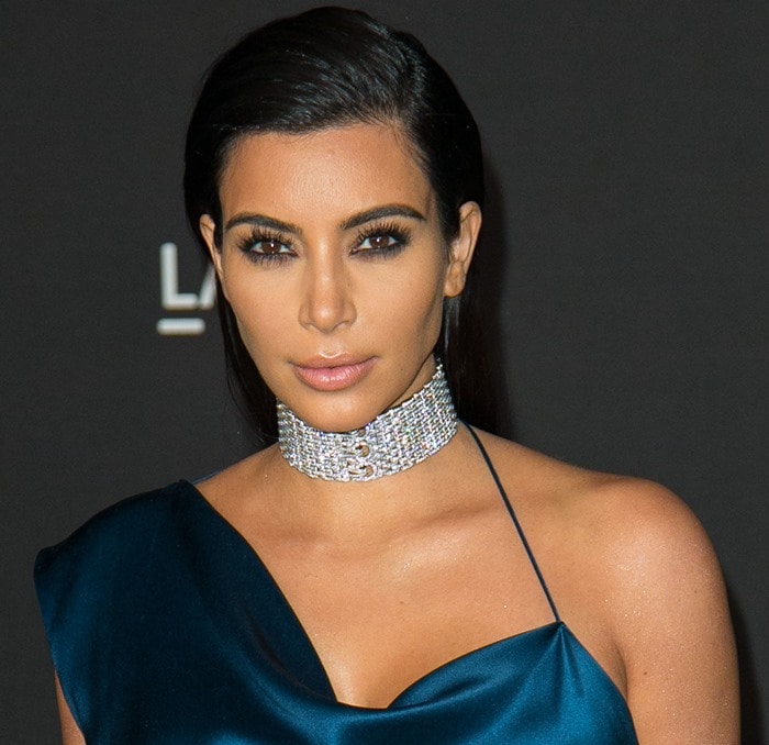 Kim Kardashian elevates her teal satin gown with a dazzling Cartier choker necklace
