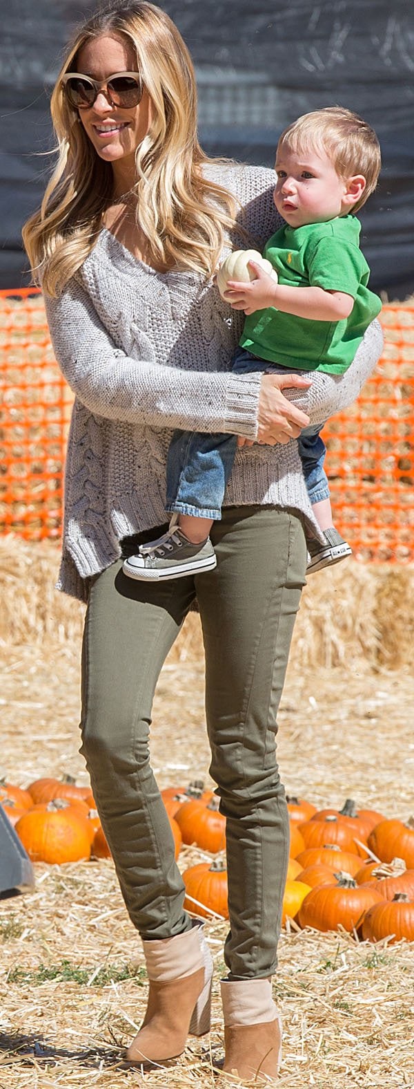Kristin Cavallari in a cropped cable knit sweater and green pants
