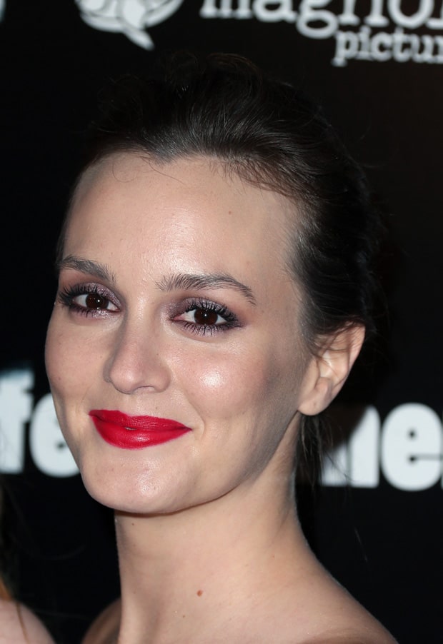 Leighton Meester's radiant look is completed with bold red lipstick and subtle eye makeup
