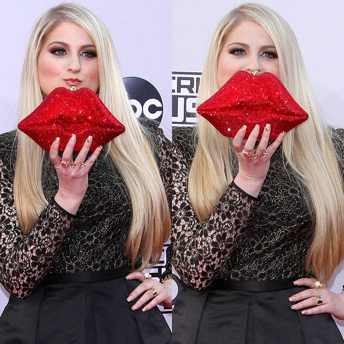Meghan Trainor posing with her red lips clutch at the 2014 American Music Awards