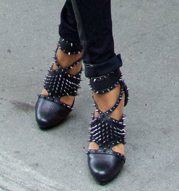 A close-up highlights her studded BCBGMAXAZRIA pumps, where spiked straps and ankle cuffs bring attitude and structure to an otherwise streamlined outfit