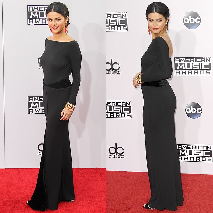 Selena Gomez exudes minimalist glamour in a black Armani Privé gown, subtly revealing her sleek black sandals as she walks the 2014 American Music Awards red carpet