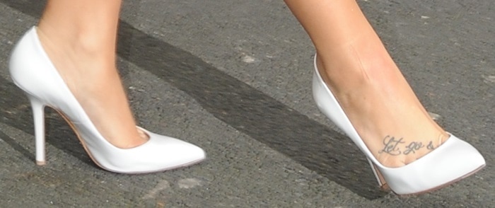 Demi Lovato shows off her feet in white patent leather pumps