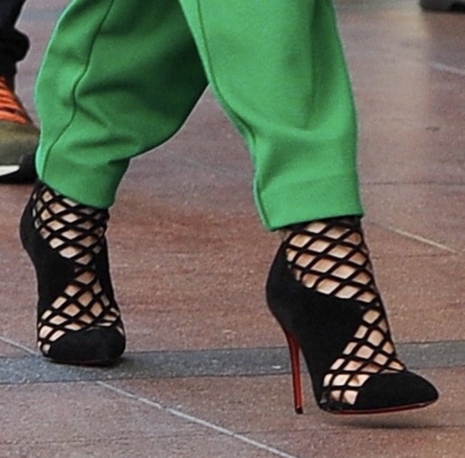 Jennifer Lopez wearing Christian Louboutin Mrs Boulglione Encage cutout booties with red soles