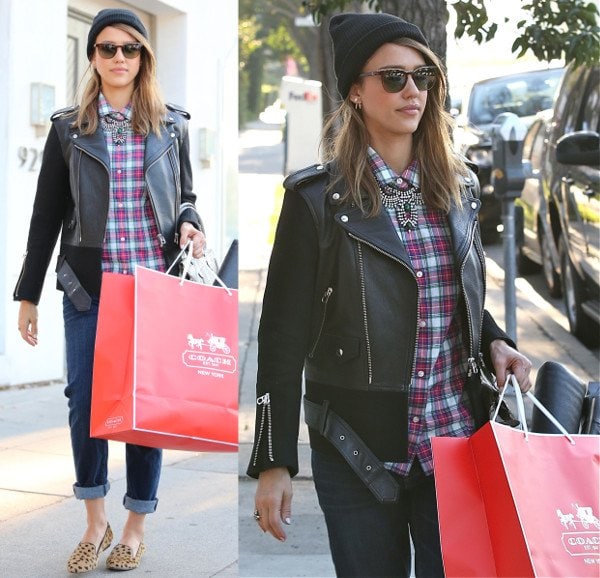 Jessica Alba wears a beanie with cheetah print flats and a leather jacket