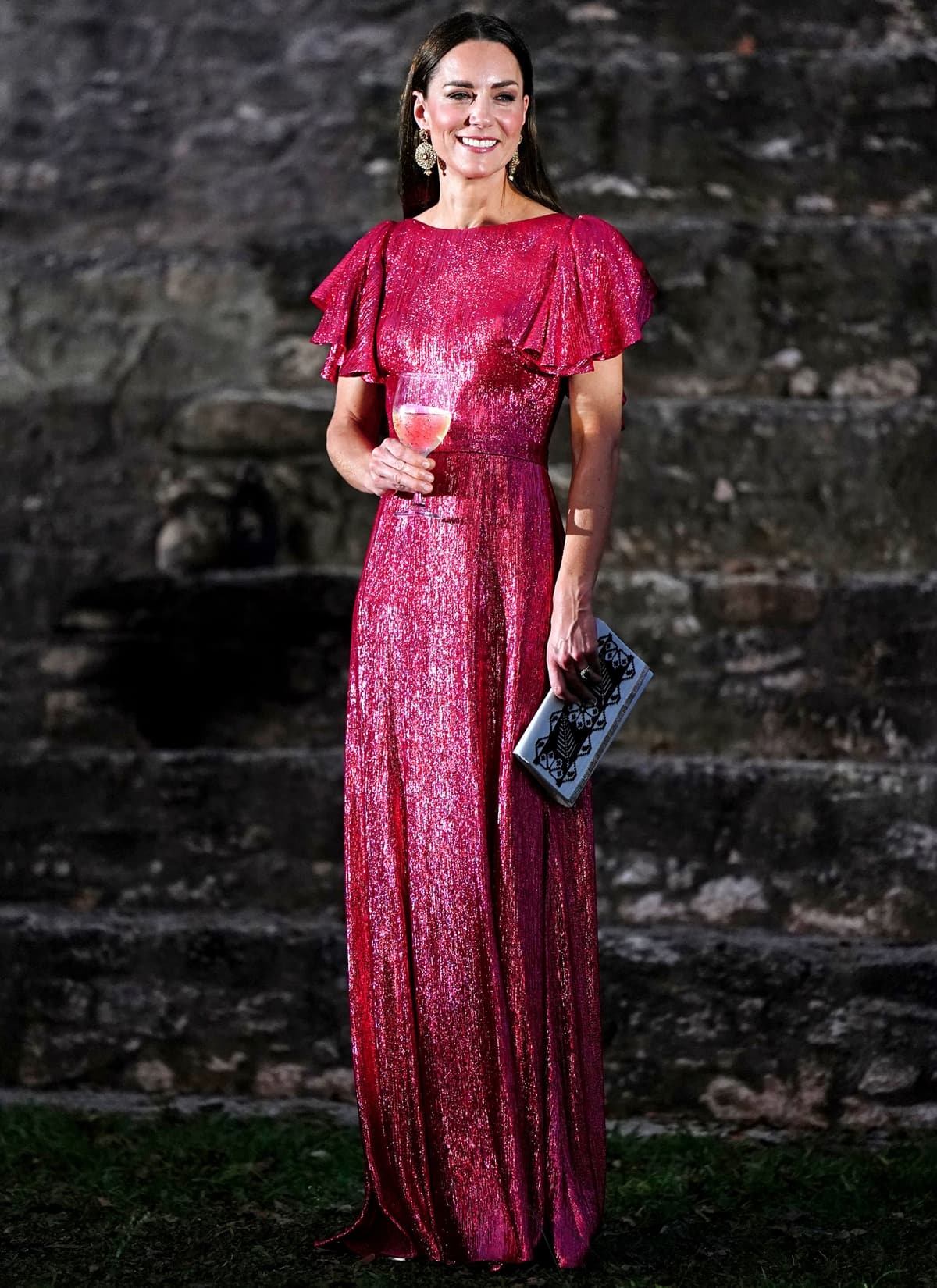 Catherine wore a custom metallic pink version of The Vampire's Wife's "Light Sleeper" gown with Jimmy Choo "Mimi" 100 sandals at Cahal Pech in Belize