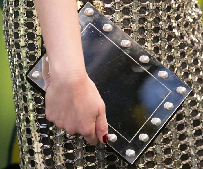 A closer look at Christina Hendricks' Charlotte Olympia Mirror Mirror Pandora clutch, featuring a mirrored panel and faux-pearl embellishments