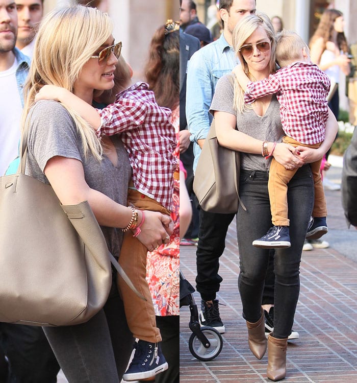 Hilary Duff in a gray V-neck tee tucked into a pair of dark skinny jeans