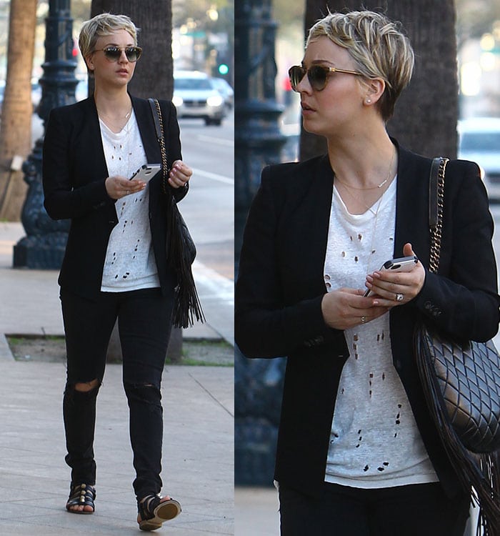 Kaley Cuoco kept it edgy yet effortless in ripped black Rag Bone skinny jeans, a distressed white IRO tee, a tailored black blazer, and black studded Balenciaga leather sandals featuring caged vamps and gold hardware—perfect for a stylish off-duty stroll