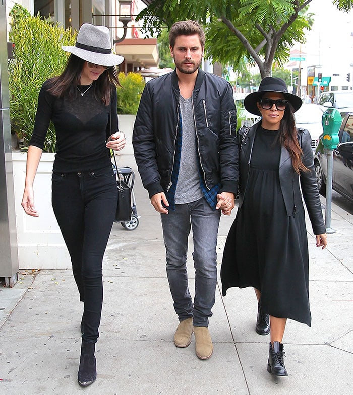 Kendall Jenner in black skinny jeans and Saint Laurent Duckies boots walking with Scott Disick and Kourtney Kardashian in Beverly Hills