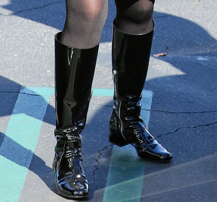 A side view highlights the boots’ sculpted silhouette and low block heels—proof that polished comfort can still look commanding