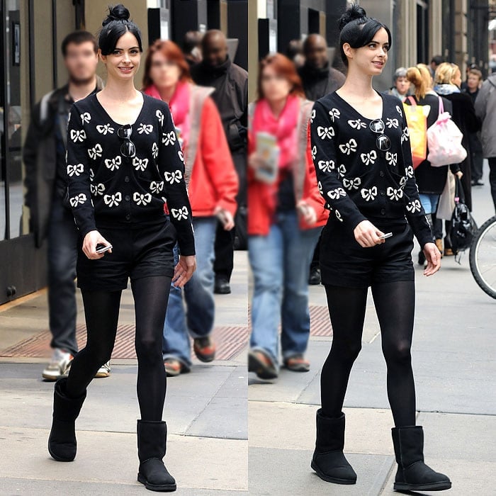 Krysten Ritter mixes cute and edgy with all-black shorts, a ribbon-print cardigan, leggings, and Ugg boots while filming the TV movie Assistance in New York City on April 1, 2013