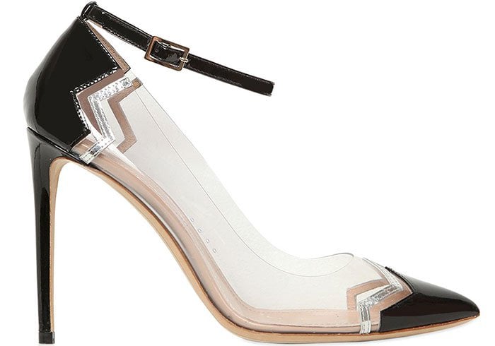 The Nicholas Kirkwood “Mirage” pump features a sharply pointed patent toe, clear PVC body, and the designer’s signature zigzag trim for a modern, sculptural finish
