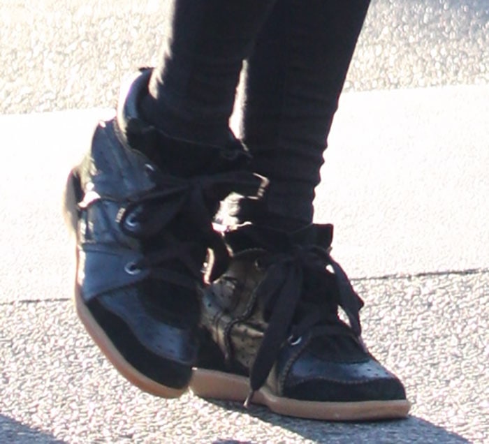 Nicky Hilton steps out in black Isabel Marant “Bobby” sneakers, featuring suede trims, perforated panels, and hidden wedge heels for a subtle lift