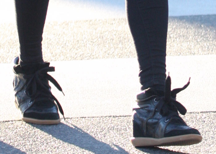 Nicky Hilton steps out in black Isabel Marant “Bobby” sneakers, featuring suede trims, perforated panels, and hidden wedge heels for a subtle lift