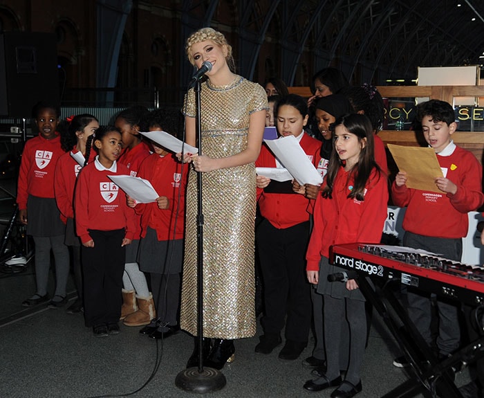 Pixie Lott performing with children from Copenhagen Primary School to raise funds for Penny for London at St. Pancras International in London on December 16, 2014