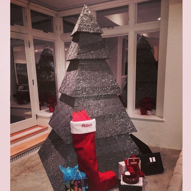 Rihanna's luxurious black pyramid Christmas tree, encrusted with sparkling crystals, stands proudly beside her personalized stocking embroidered with her real name, Robyn