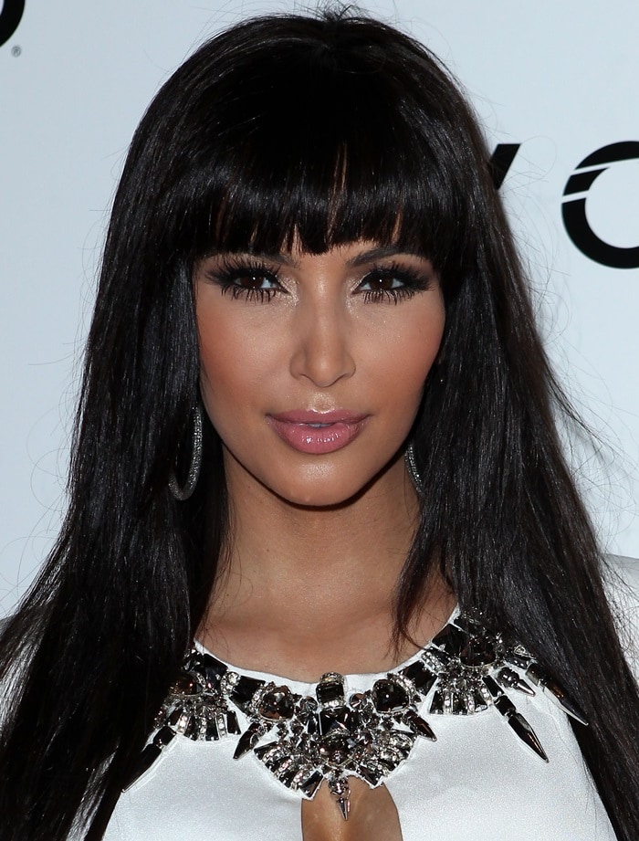 Kim Kardashian in a white Gucci dress with an embellished neckline